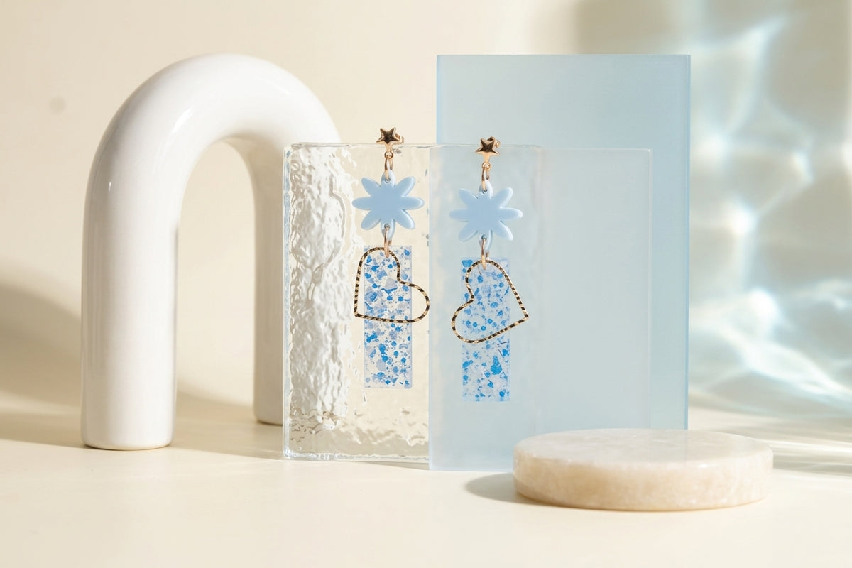 Blue Ines floral heart dangle earrings in a styled product setting