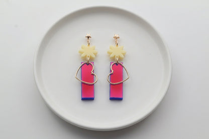 HB Ines floral heart dangle earrings arranged on a white plate