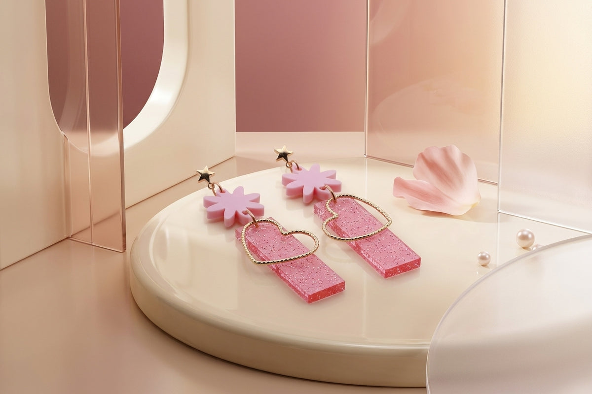 Pink Ines floral heart dangle earrings in a styled product setting