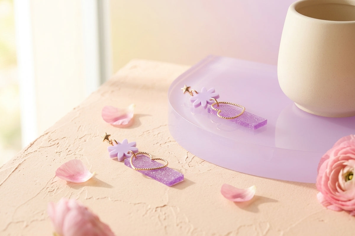 Purple Ines floral heart dangle earrings in a styled product setting