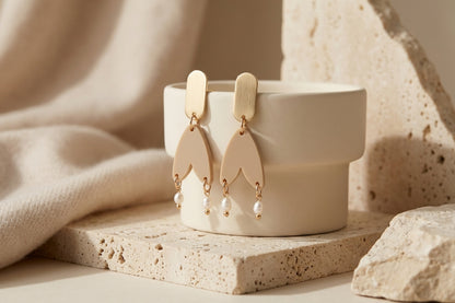 Beige Iris geometric long drop earrings in a styled product setting