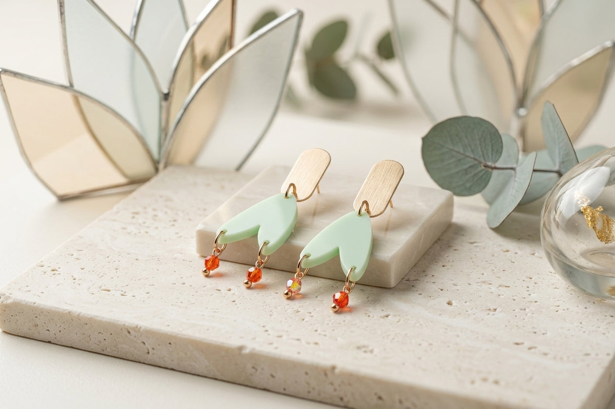 Green Iris geometric long drop earrings in a styled product setting