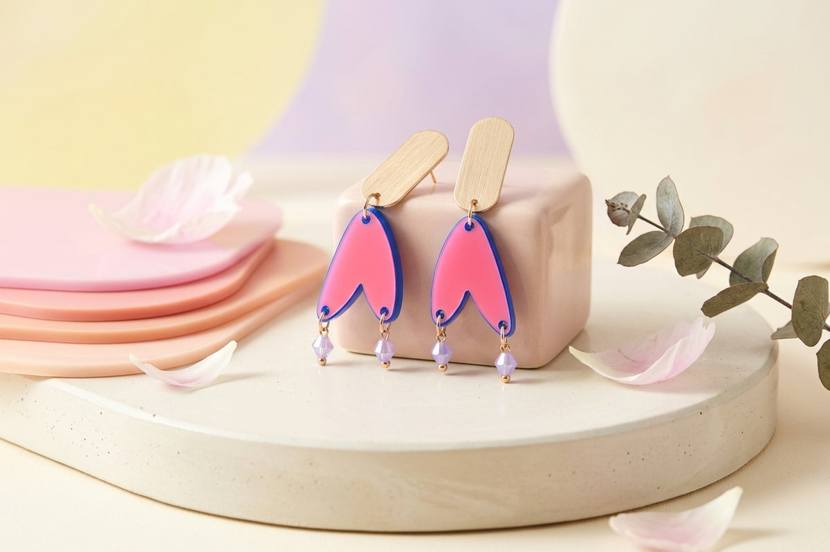 HB Iris geometric long drop earrings in a styled product setting