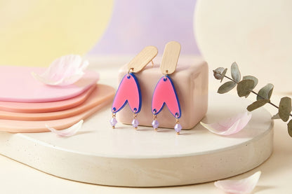 HB Iris geometric long drop earrings in a styled product setting