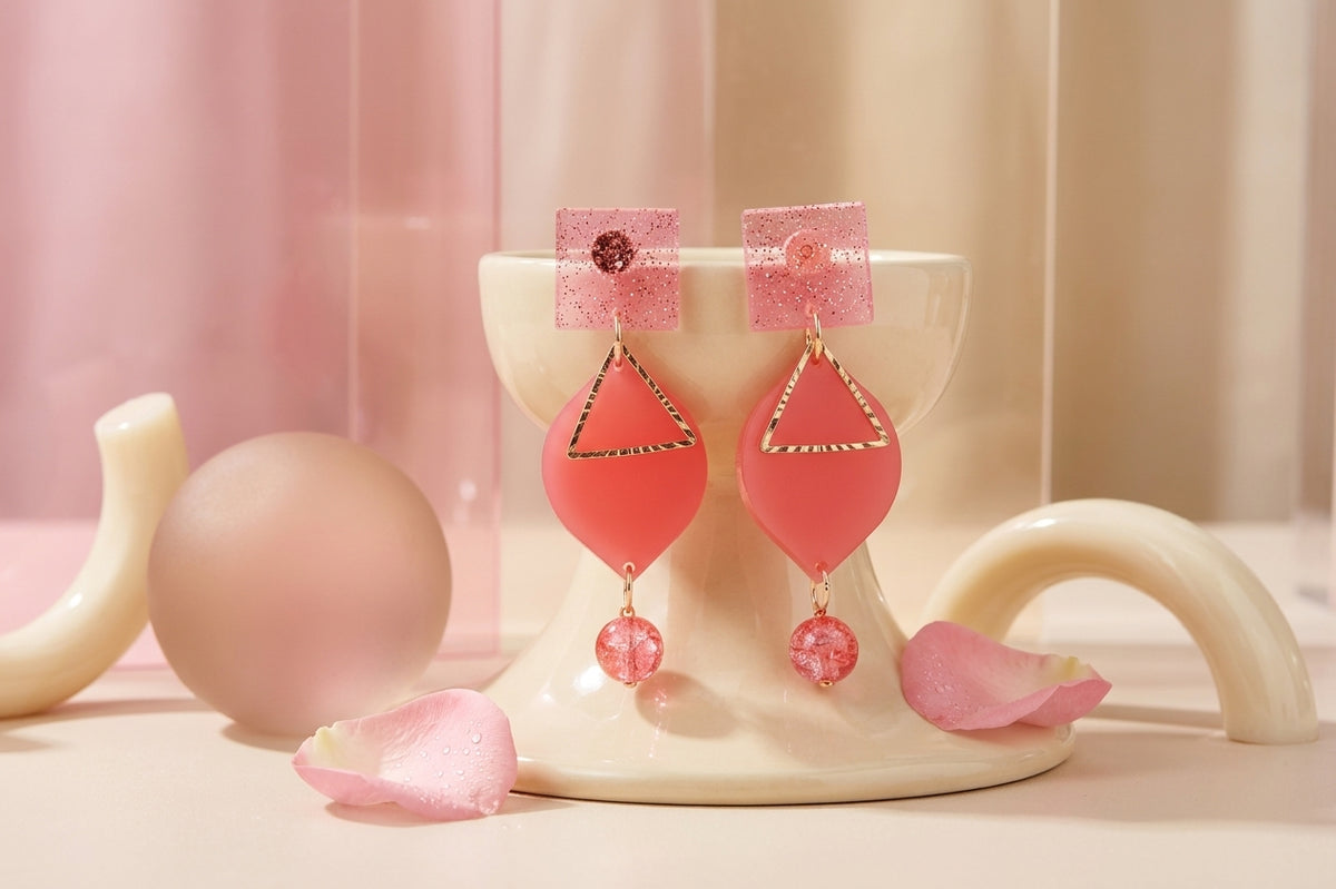 Pink Lara heart acrylic dangle earrings in a styled product setting