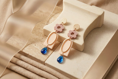 Beige Lena floral long drop earrings in a styled product setting