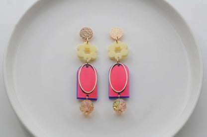 HB Lena floral long drop earrings arranged on a white plate