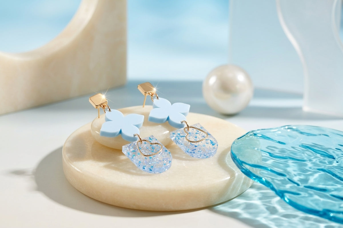 Blue Lia floral heart drop earrings in a styled product setting