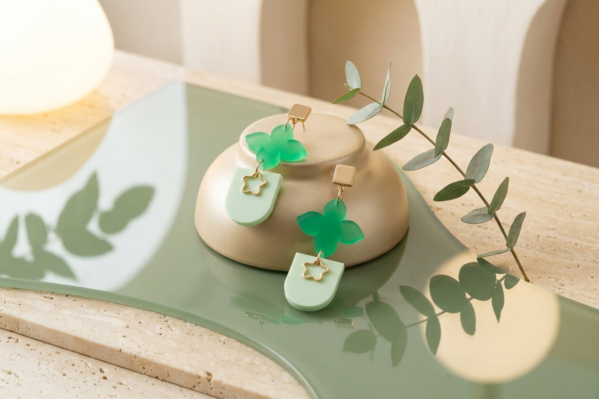 Green Lia floral heart drop earrings in a styled product setting