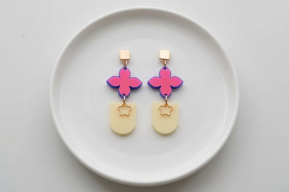 HB Lia floral heart drop earrings arranged on a white plate