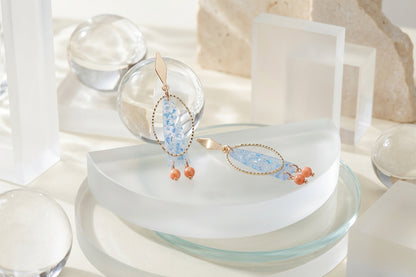 Blue Lina long geometric acrylic earrings in a styled product setting