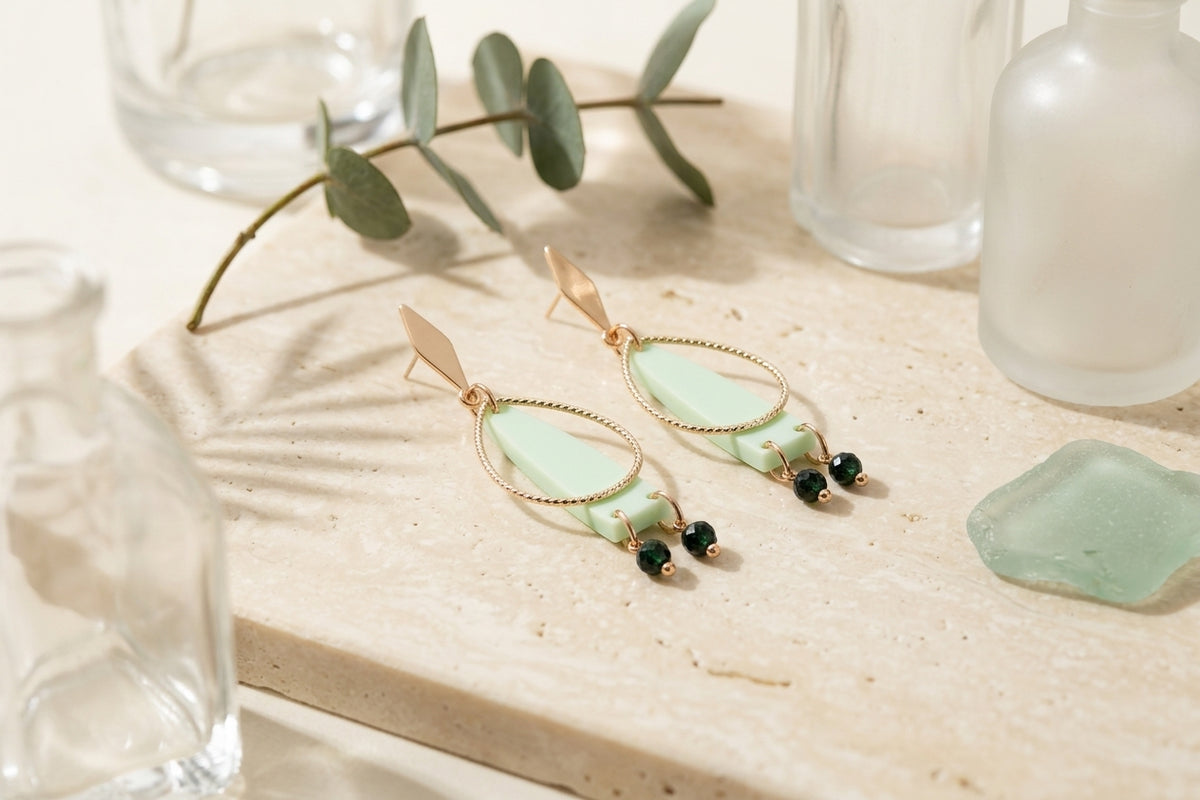 Green Lina long geometric acrylic earrings in a styled product setting