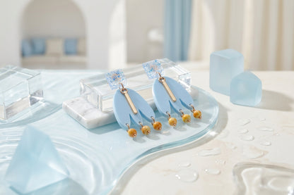 Blue Liv acrylic beaded statement earrings in a styled product setting