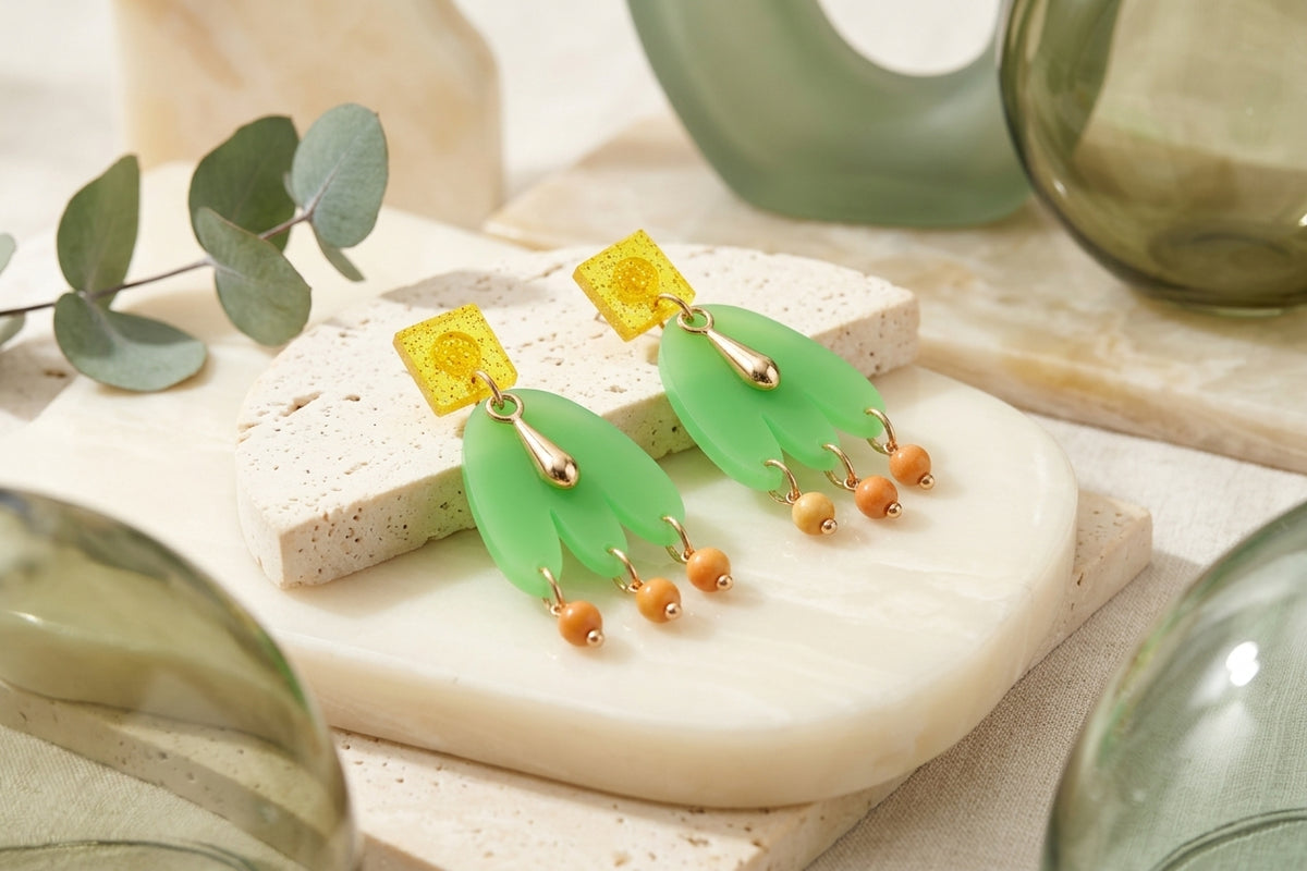 Green Liv acrylic beaded statement earrings in a styled product setting