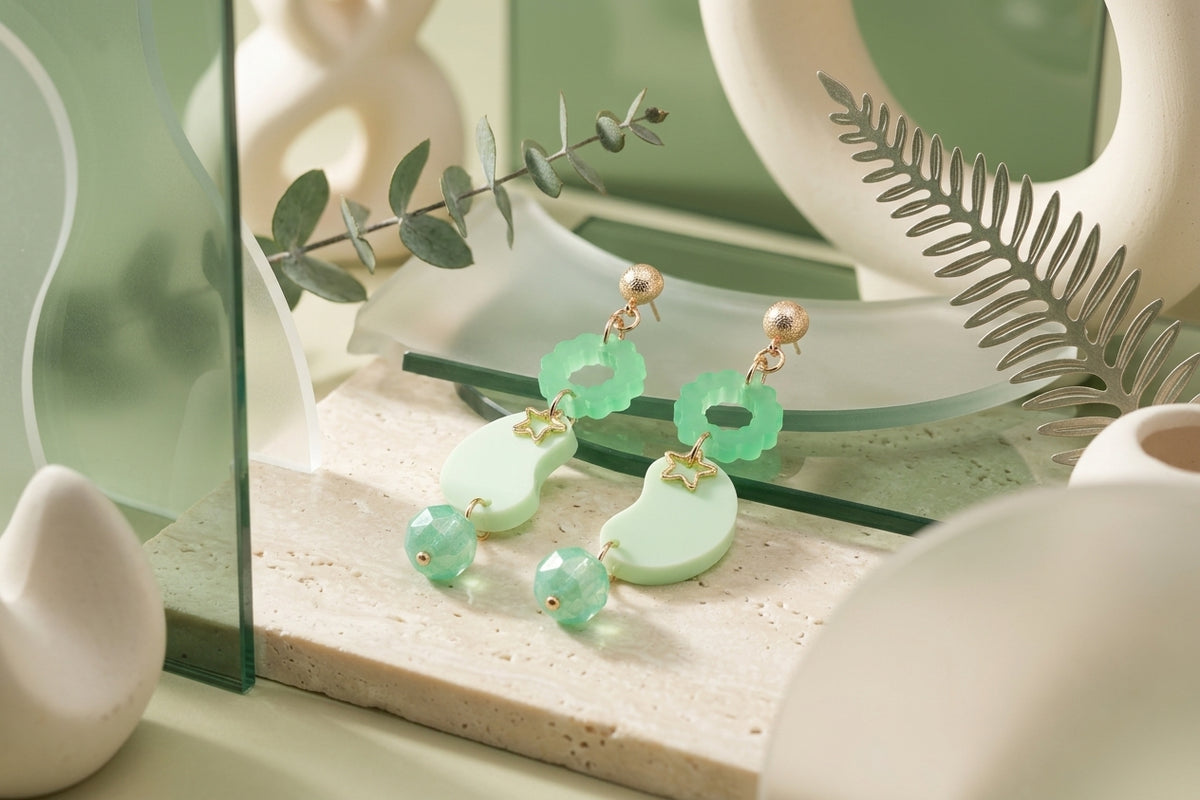 Green Lucia floral star dangle earrings in a styled product setting