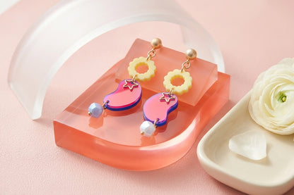 HB Lucia floral star dangle earrings in a styled product setting