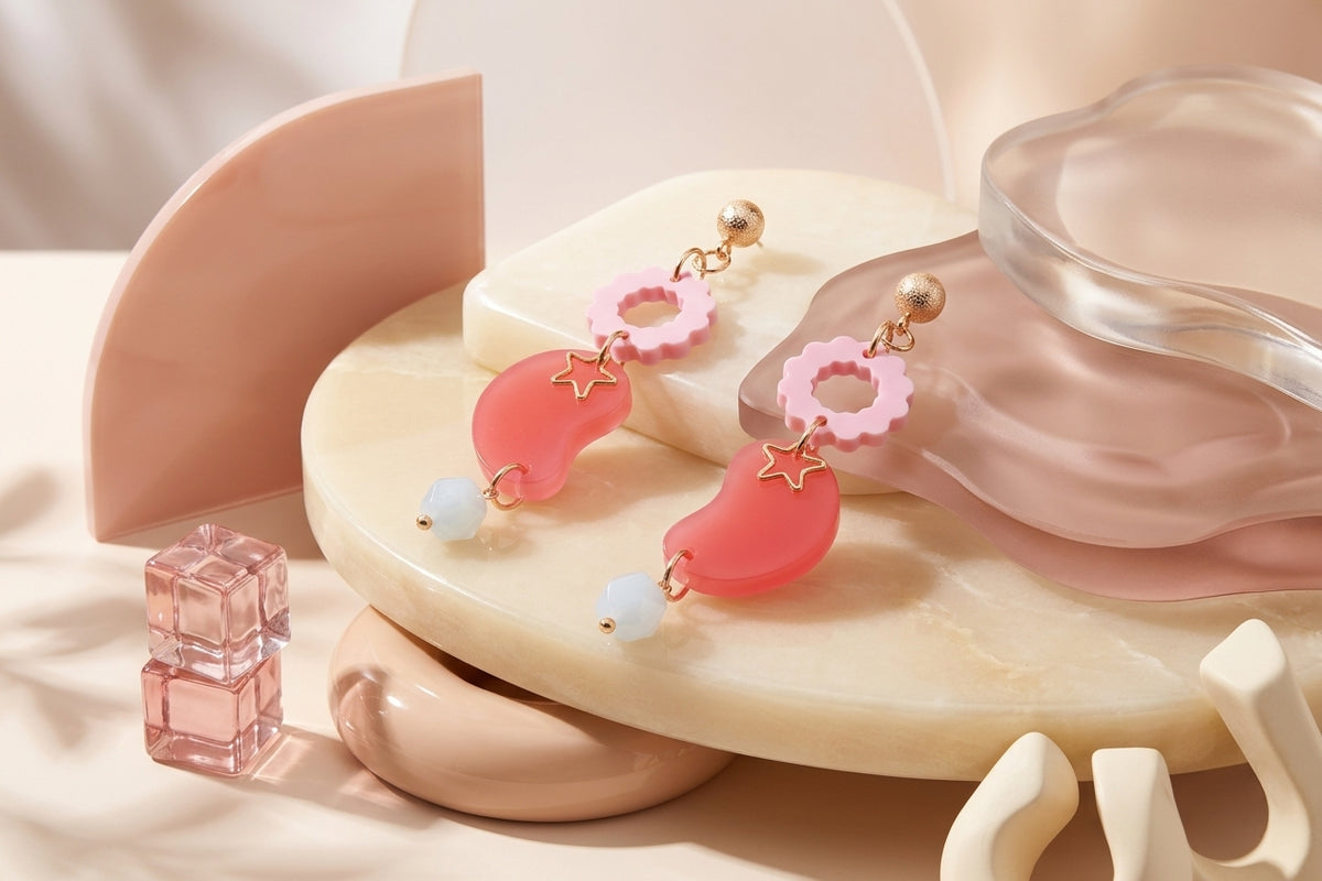 Pink Lucia floral star dangle earrings in a styled product setting