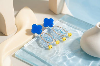 Blue Maud flower statement earrings in a styled product setting