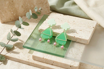 Green Maud flower statement earrings in a styled product setting