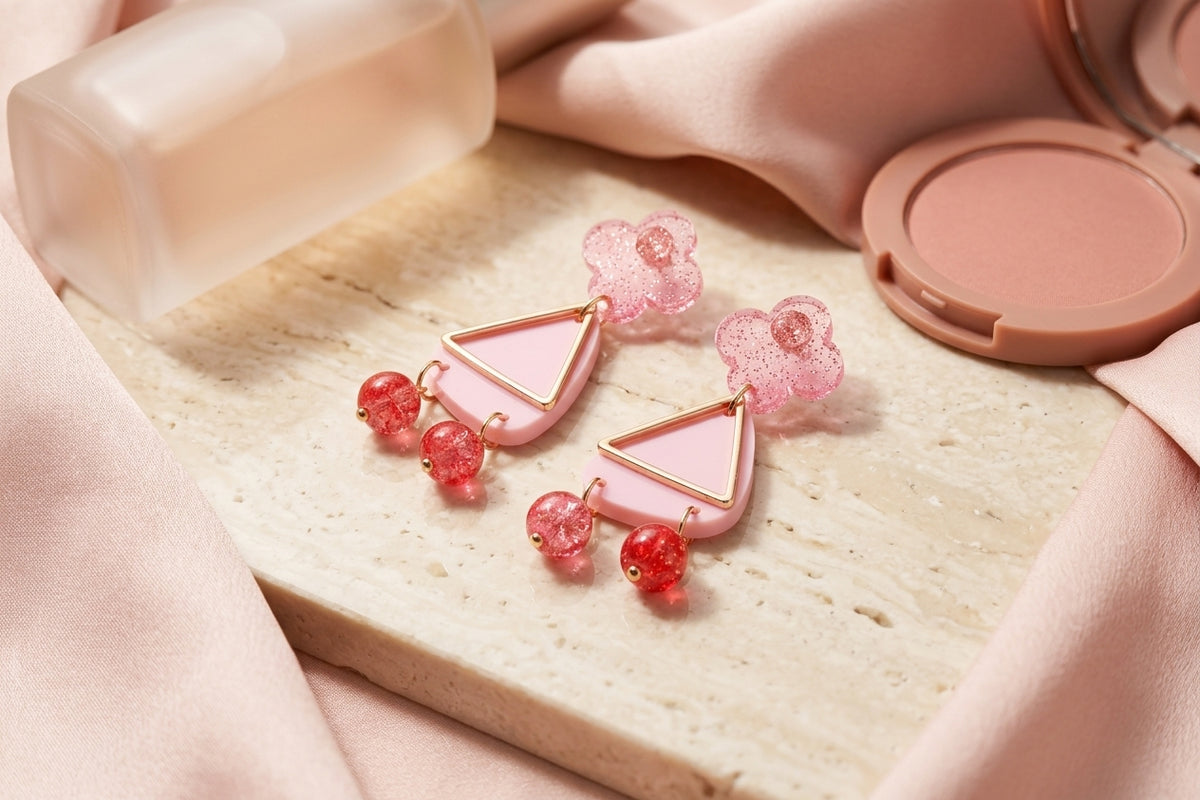 Pink Maud flower statement earrings in a styled product setting