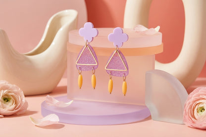 Purple Maud flower statement earrings in a styled product setting