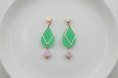 Green Mia geometric teardrop earrings arranged on a white plate