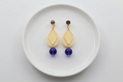 HB Mia geometric teardrop earrings arranged on a white plate