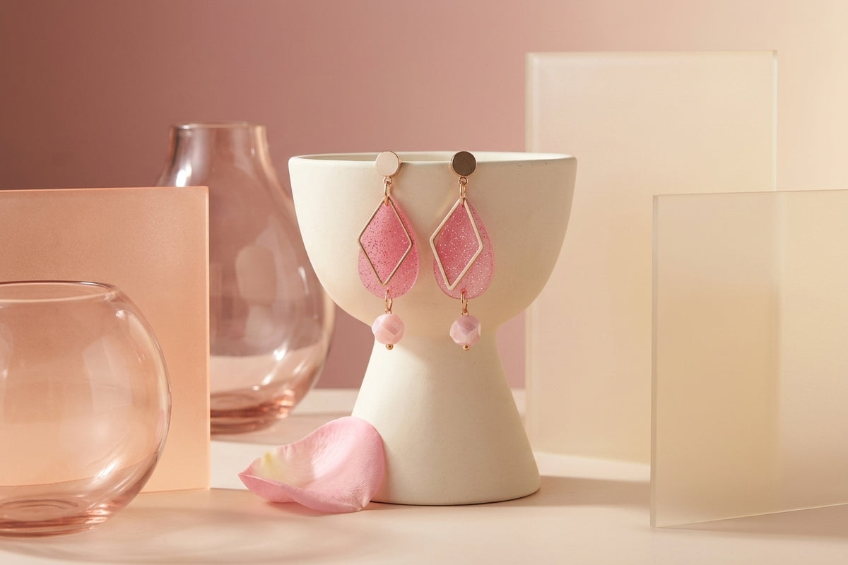 Pink Mia geometric teardrop earrings in a styled product setting