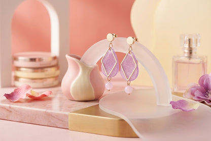 Purple Mia geometric teardrop earrings in a styled product setting
