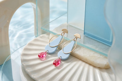 Blue Mila teardrop statement earrings in a styled product setting