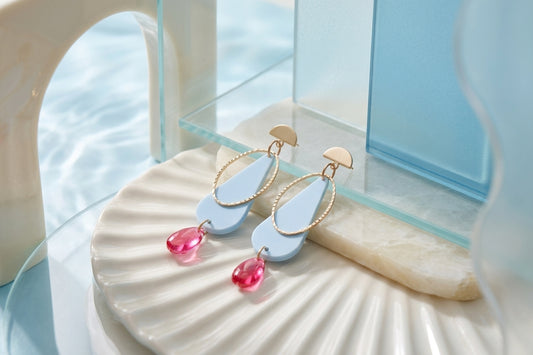 Blue Mila teardrop statement earrings in a styled product setting