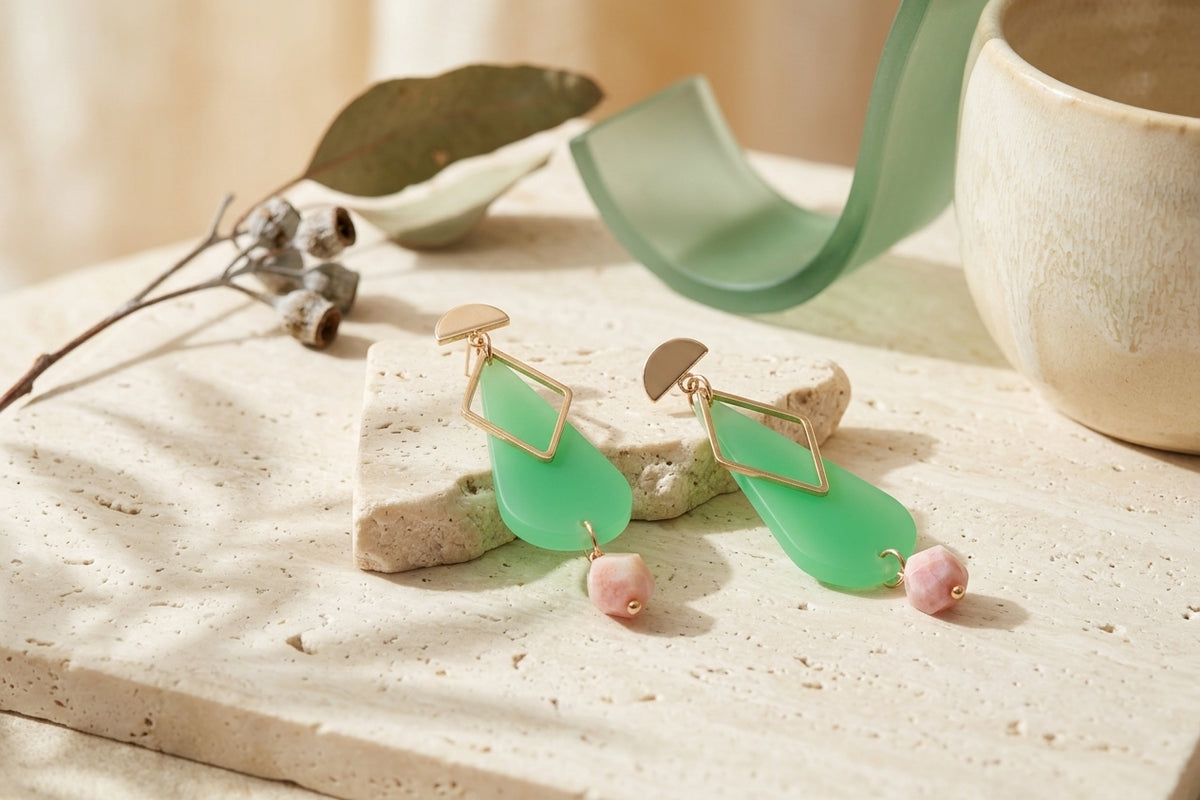 Green Mila teardrop statement earrings in a styled product setting