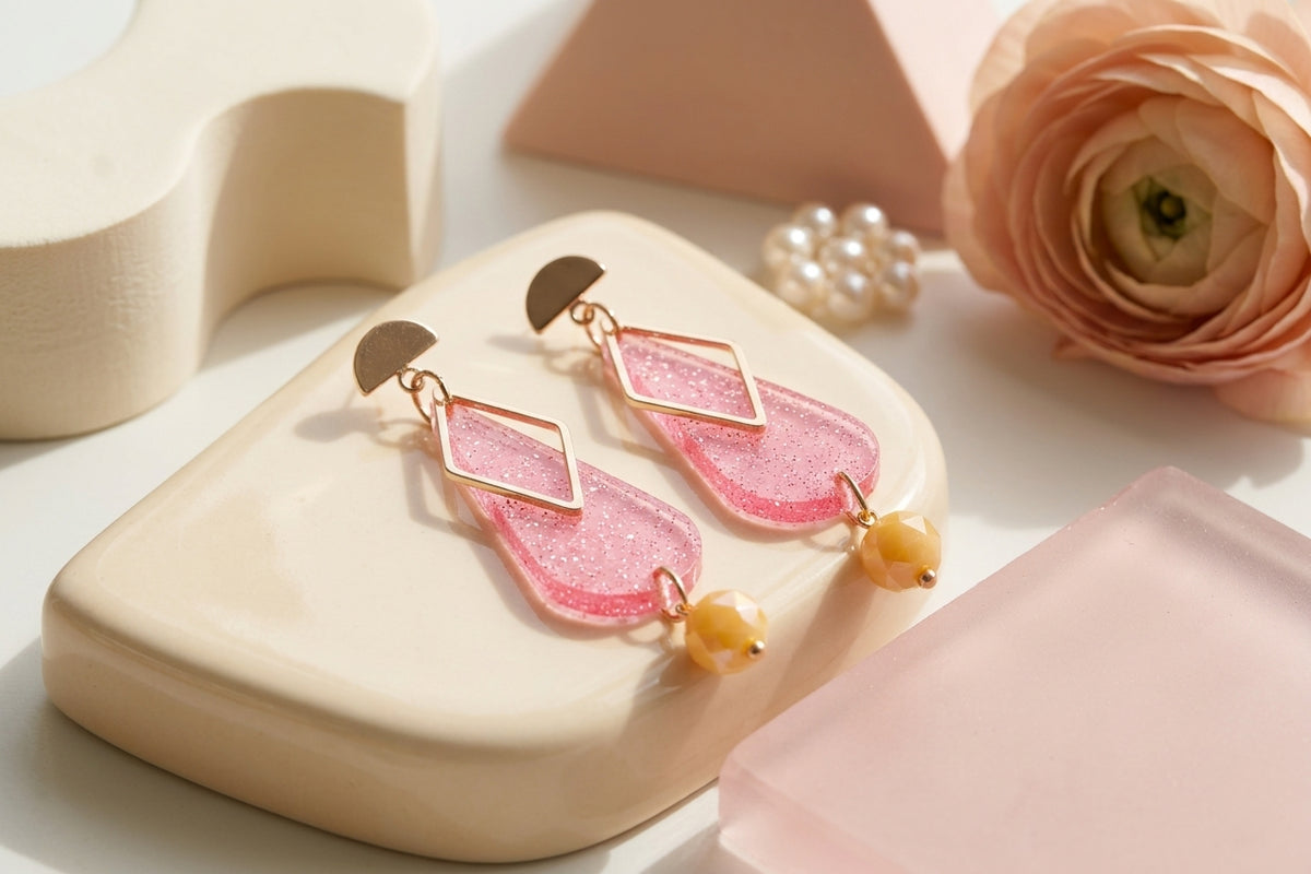 Pink Mila teardrop statement earrings in a styled product setting