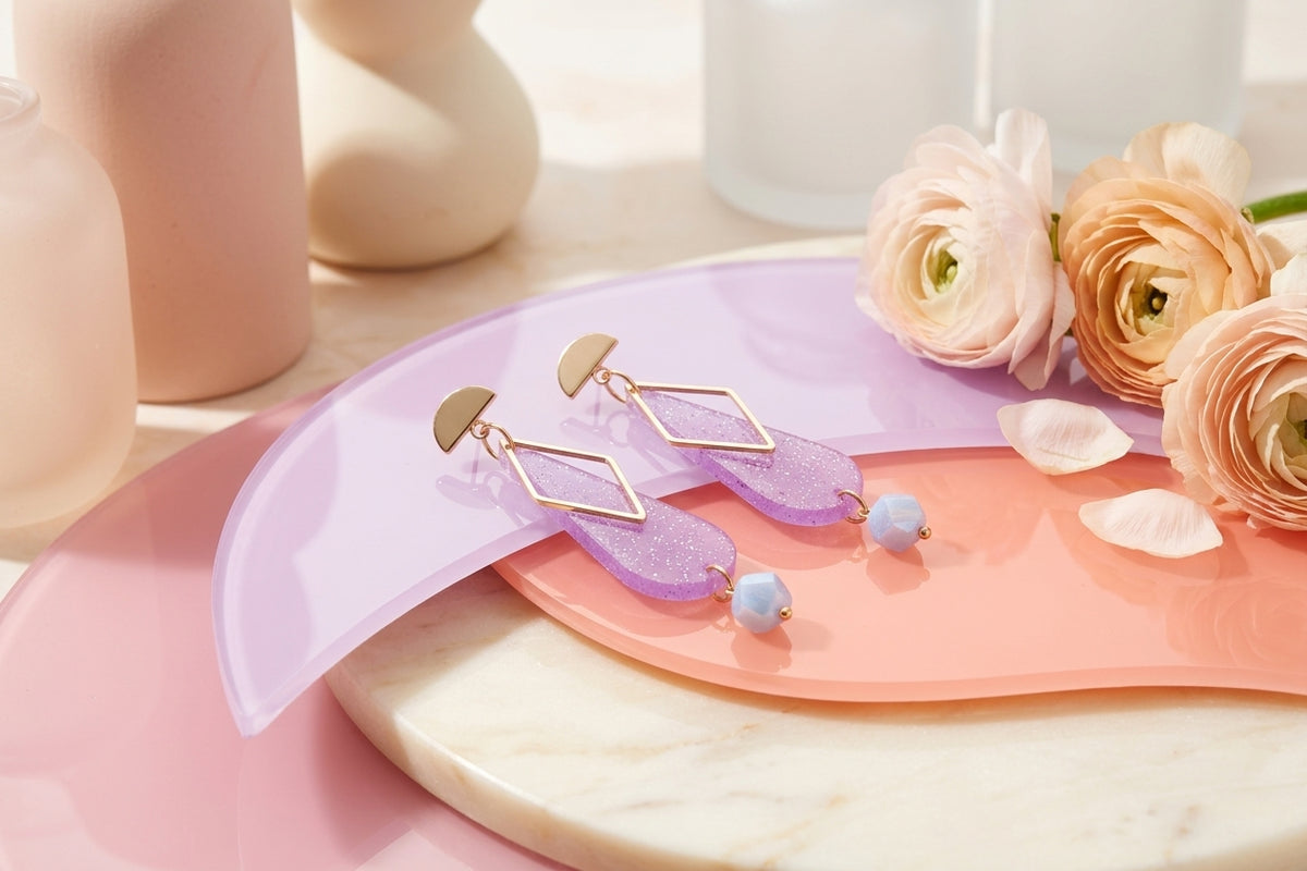 Purple Mila teardrop statement earrings in a styled product setting