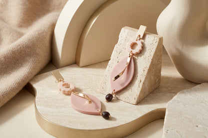 Beige Nia long geometric statement earrings in a styled product setting