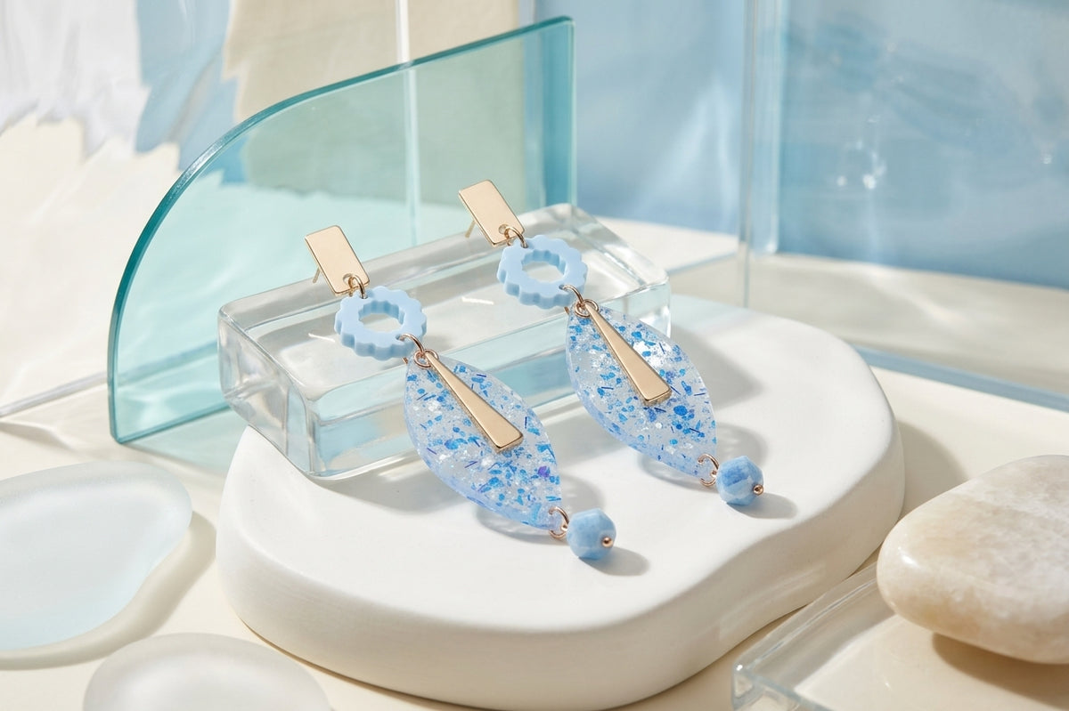 Blue Nia long geometric statement earrings in a styled product setting
