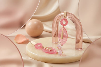 Pink Nia long geometric statement earrings in a styled product setting