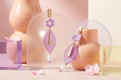 Purple Nia long geometric statement earrings in a styled product setting