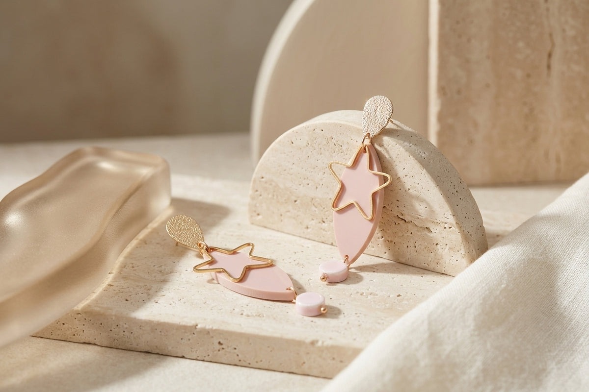 Beige Nina star geometric dangle earrings in a styled product setting
