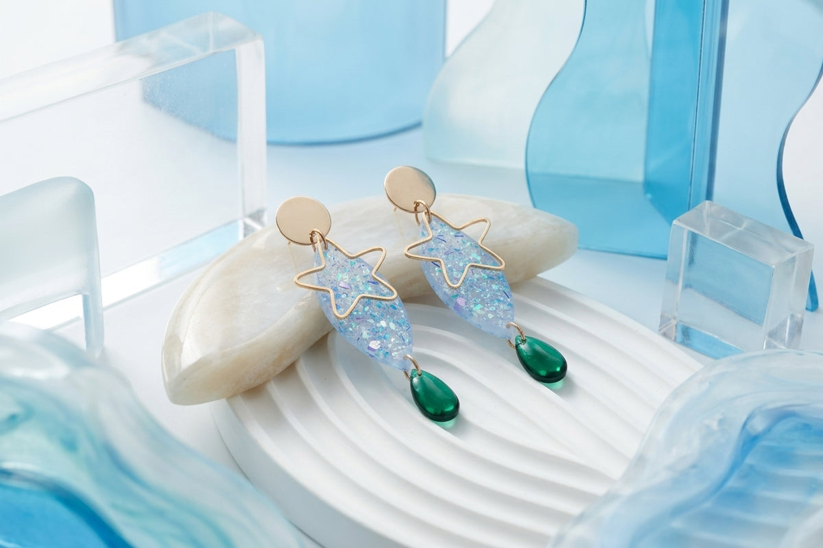 Blue Nina star geometric dangle earrings in a styled product setting