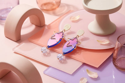 HB Nina star geometric dangle earrings in a styled product setting