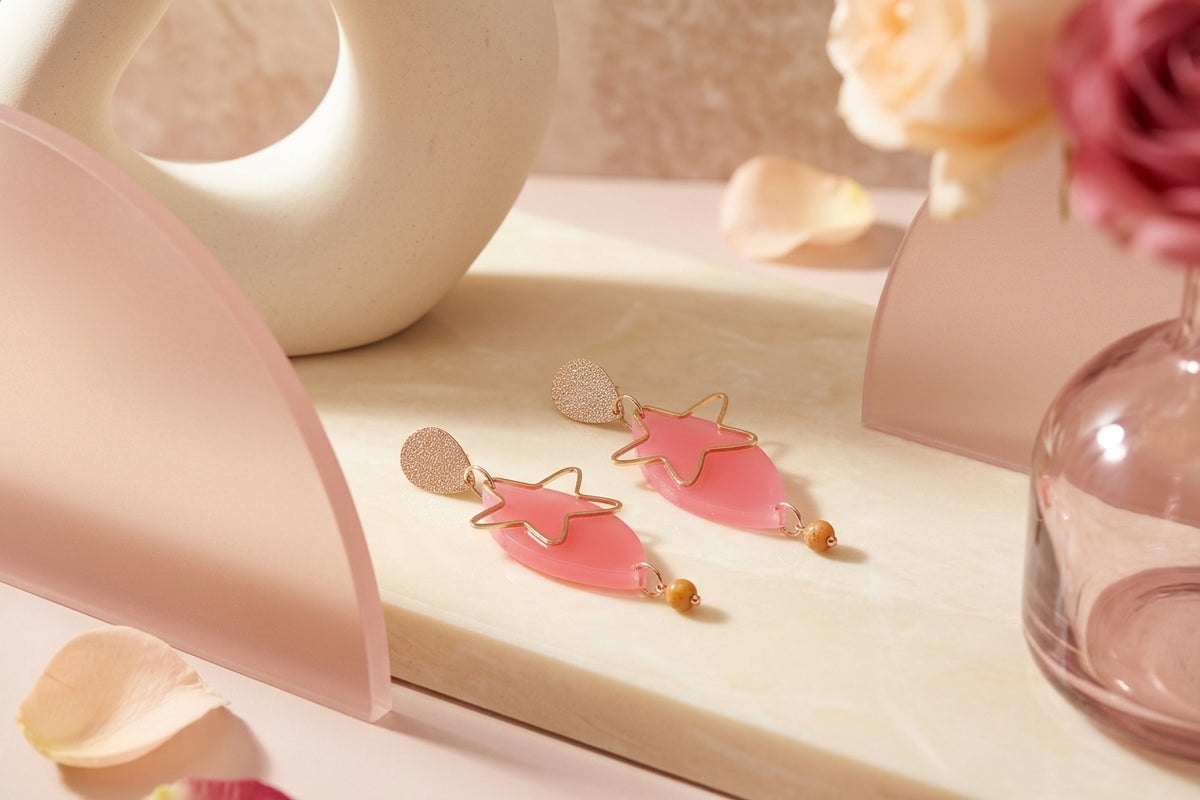 Pink Nina star geometric dangle earrings in a styled product setting