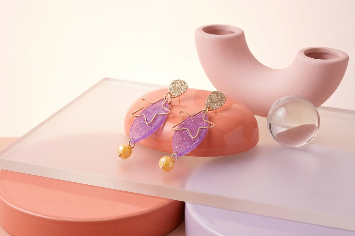 Purple Nina star geometric dangle earrings in a styled product setting