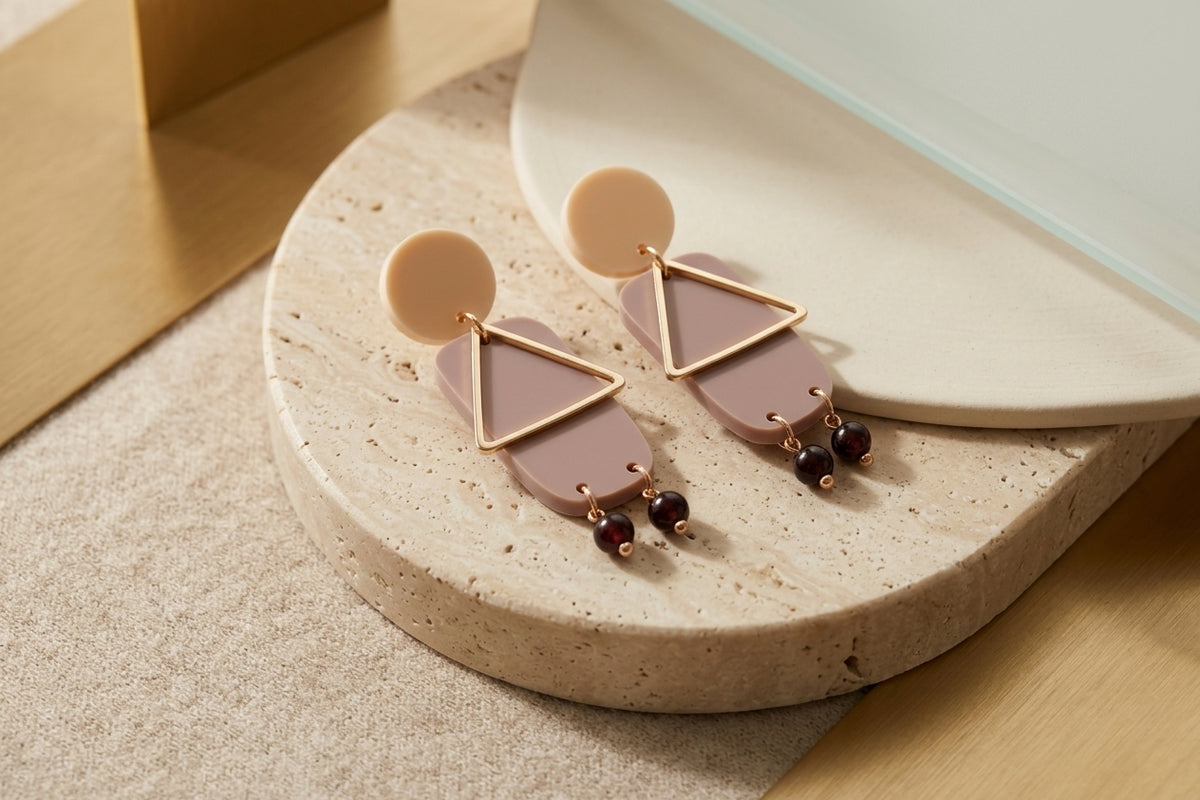 Beige Nora geometric rectangle dangle earrings in a styled product setting