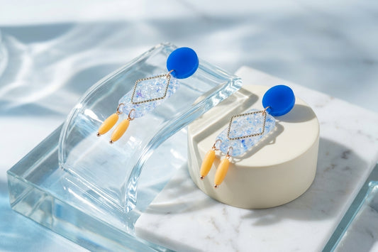 Blue Nora geometric rectangle dangle earrings in a styled product setting