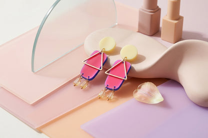 HB Nora geometric rectangle dangle earrings in a styled product setting