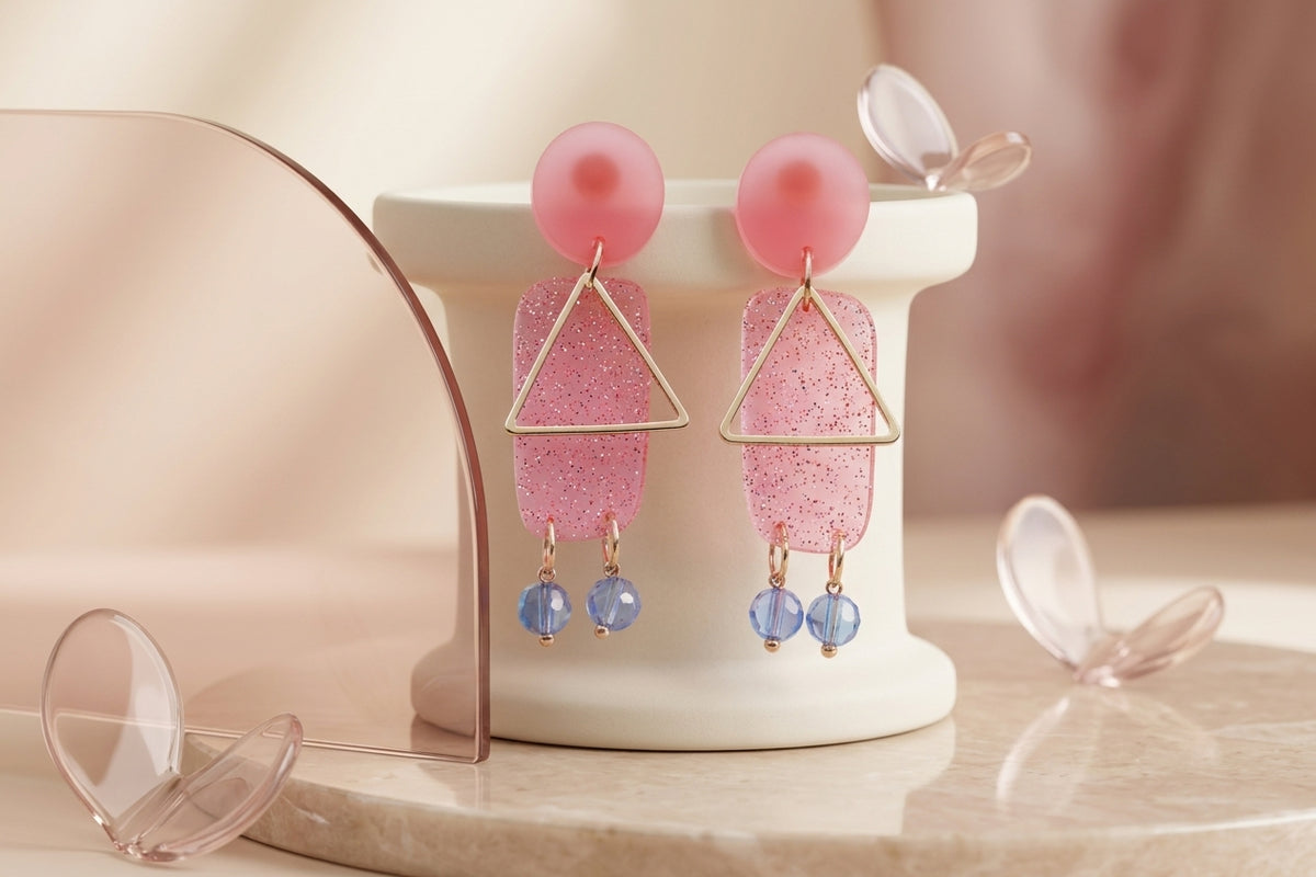 Pink Nora geometric rectangle dangle earrings in a styled product setting