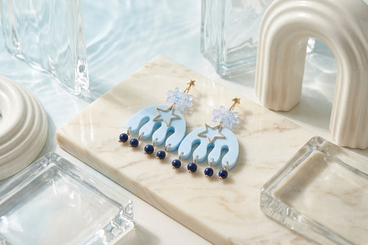 Blue Saar large flower statement earrings in a styled product setting