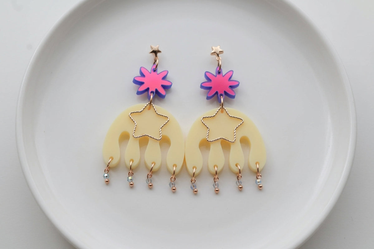 HB Saar large flower statement earrings arranged on a white plate