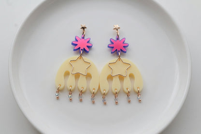 HB Saar large flower statement earrings arranged on a white plate